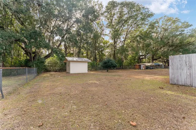 a backyard of a house with a trees and plants