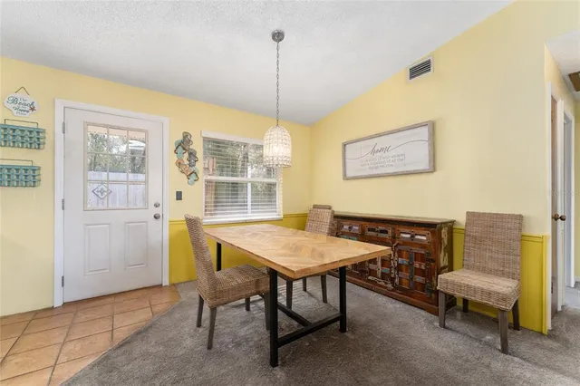 a view of a dining room with furniture and a window