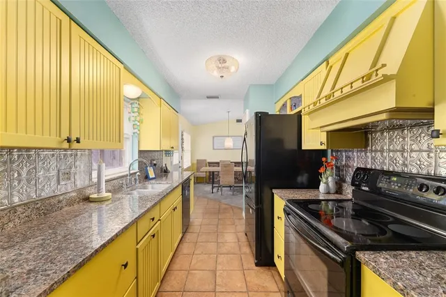 a kitchen with granite countertop lots of counter top space and stainless steel appliances