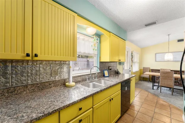 a kitchen with sink cabinets and outdoor view