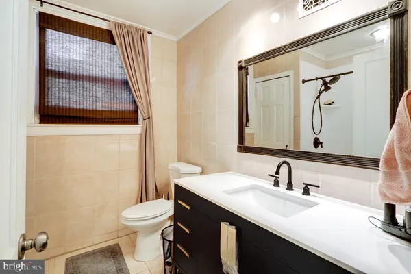 a bathroom with a sink vanity mirror and toilet