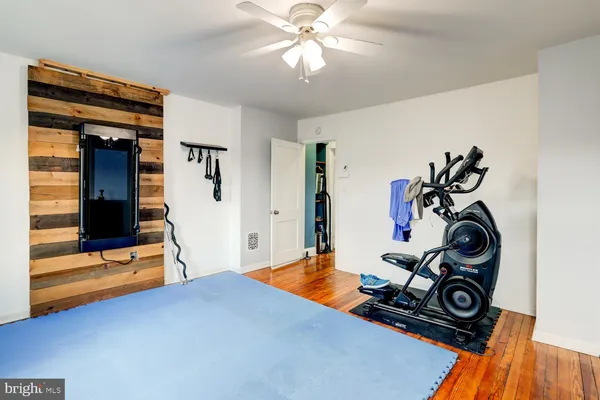 a bedroom with bed and gym equipment