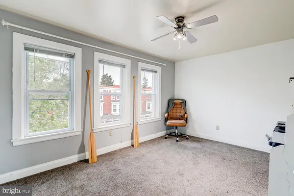 a view of a workspace with furniture and a window