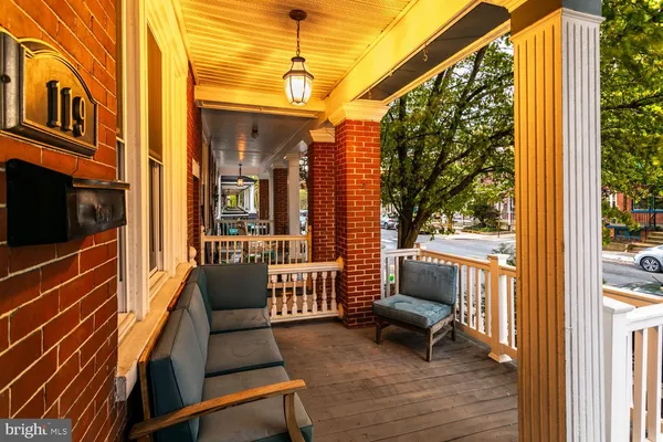 a balcony view with a couch and wooden floor