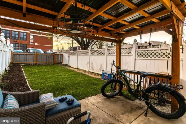 a view of a couches in patio with a swimming pool