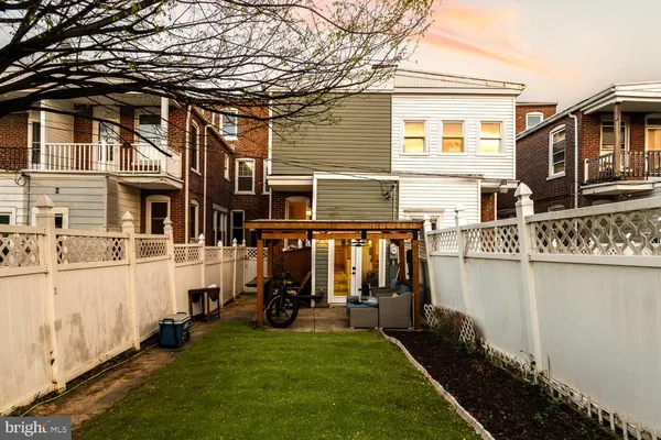 a view of a house with many windows and a yard