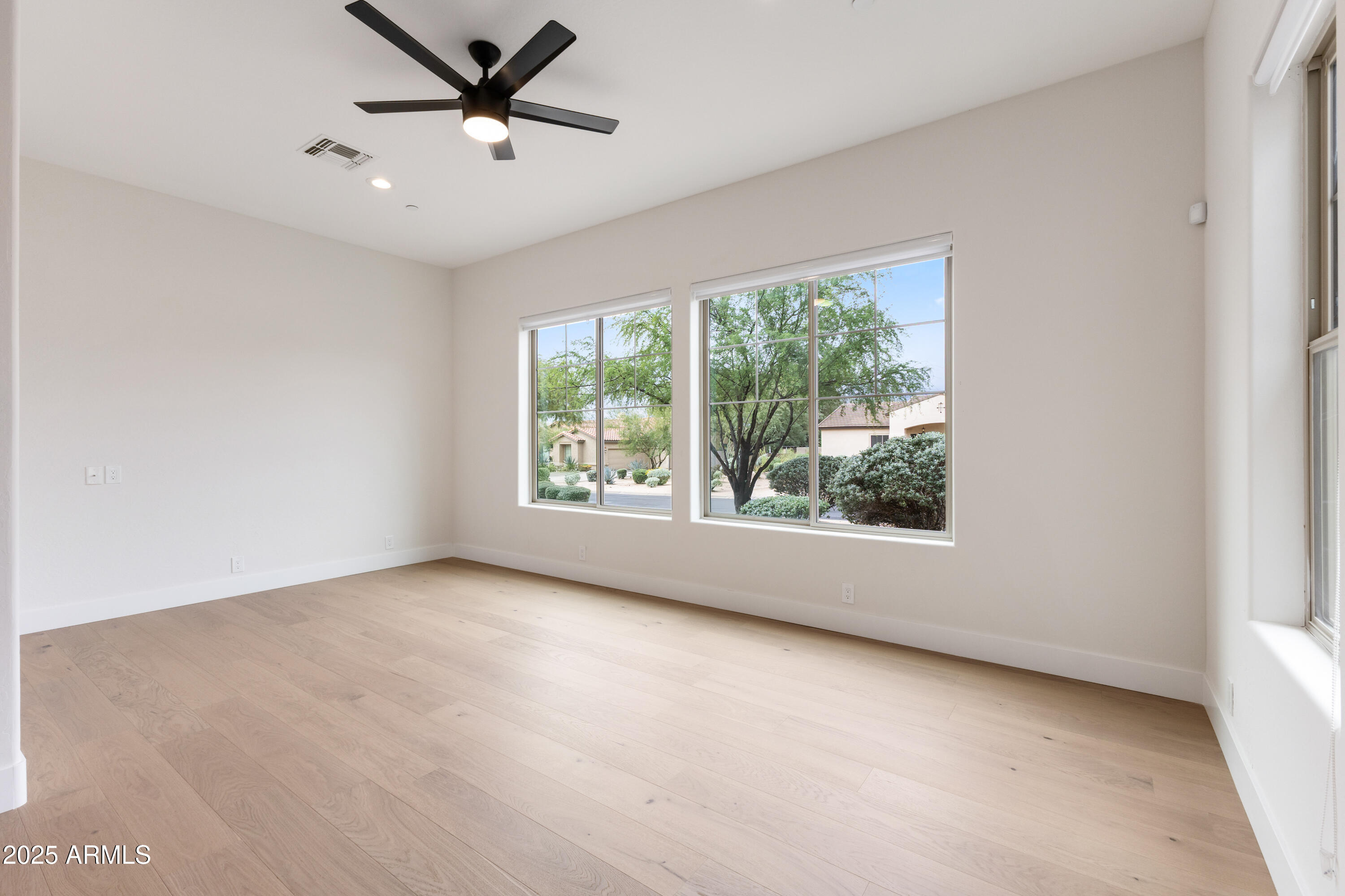 27589 North 61st Place Scottsdale, AZ 85266 - Photo 52 of 89 an empty room with a window and a ceiling fan