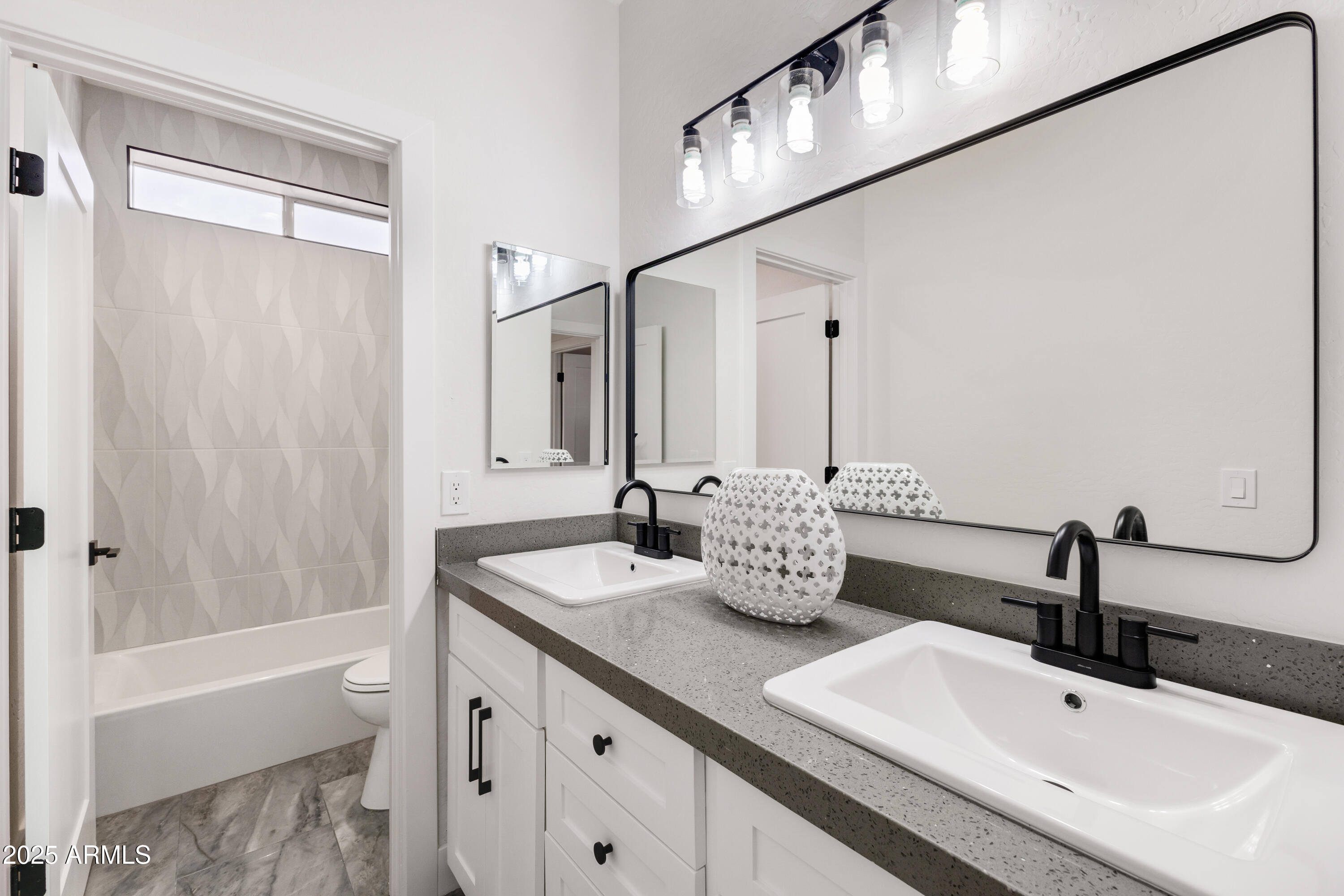 27589 North 61st Place Scottsdale, AZ 85266 - Photo 68 of 89 a bathroom with a double vanity sink and a mirror