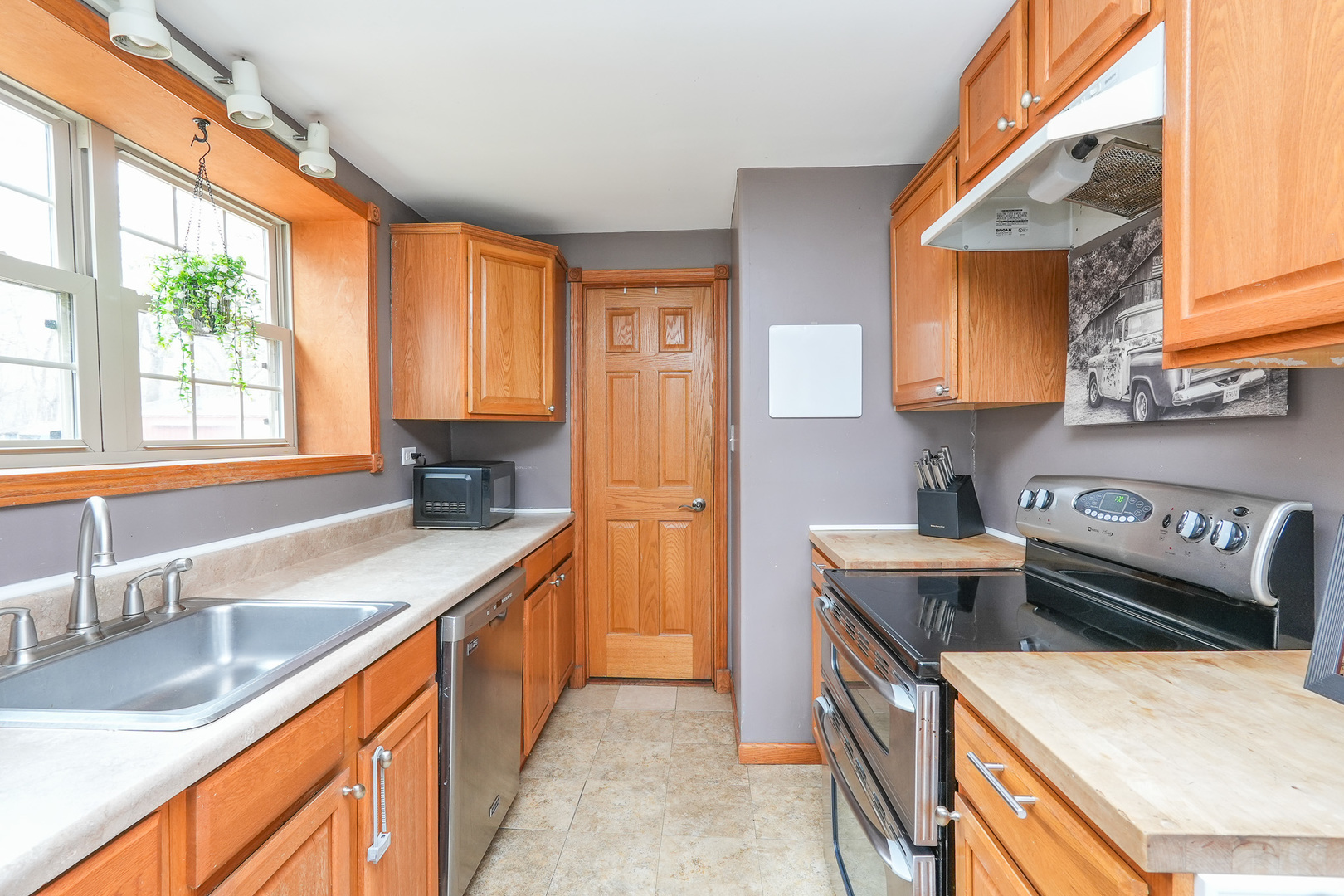2821 Shadow Road Momence, IL 60954 - Photo 16 of 50 a kitchen with stainless steel appliances granite countertop a sink a stove and a wooden cabinets