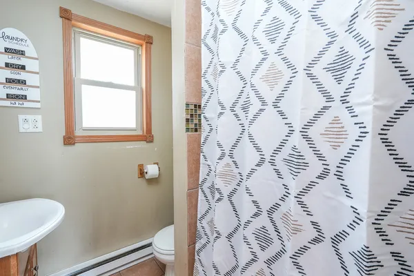 a bathroom with a sink mirror and window
