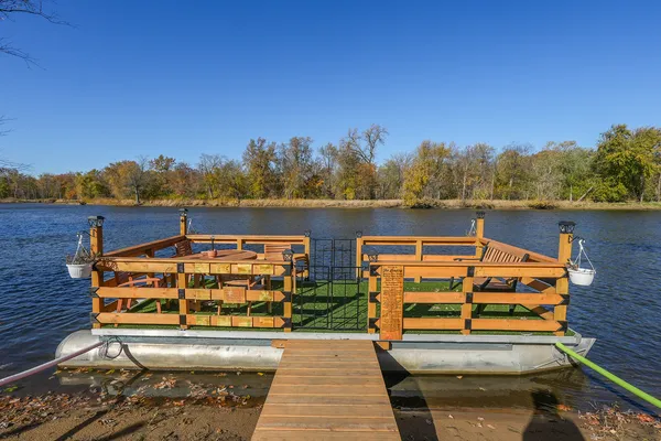 a wooden bench sitting next to a lake