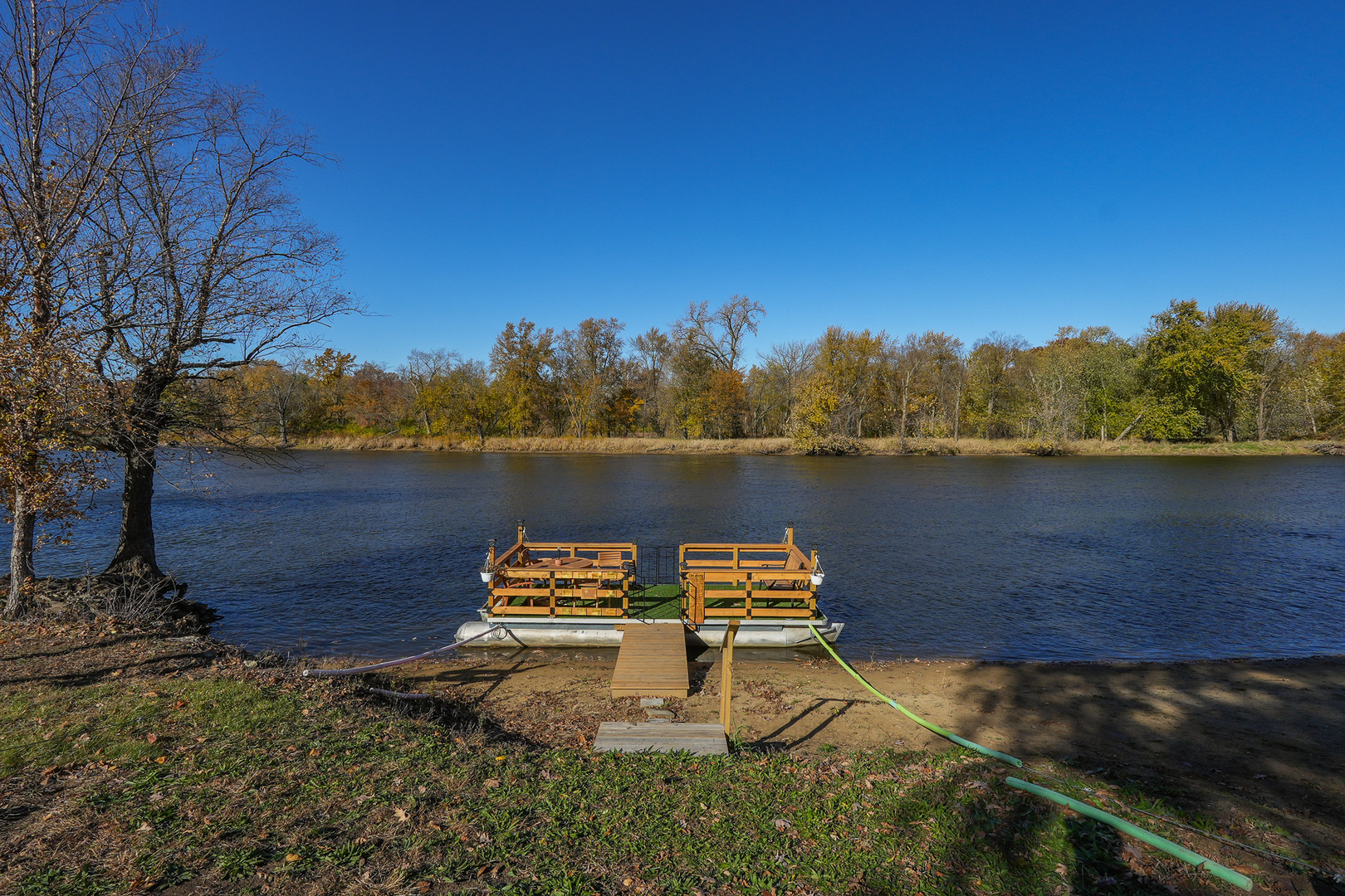 2821 Shadow Road Momence, IL 60954 - Photo 42 of 50 a wooden bench sitting next to a lake
