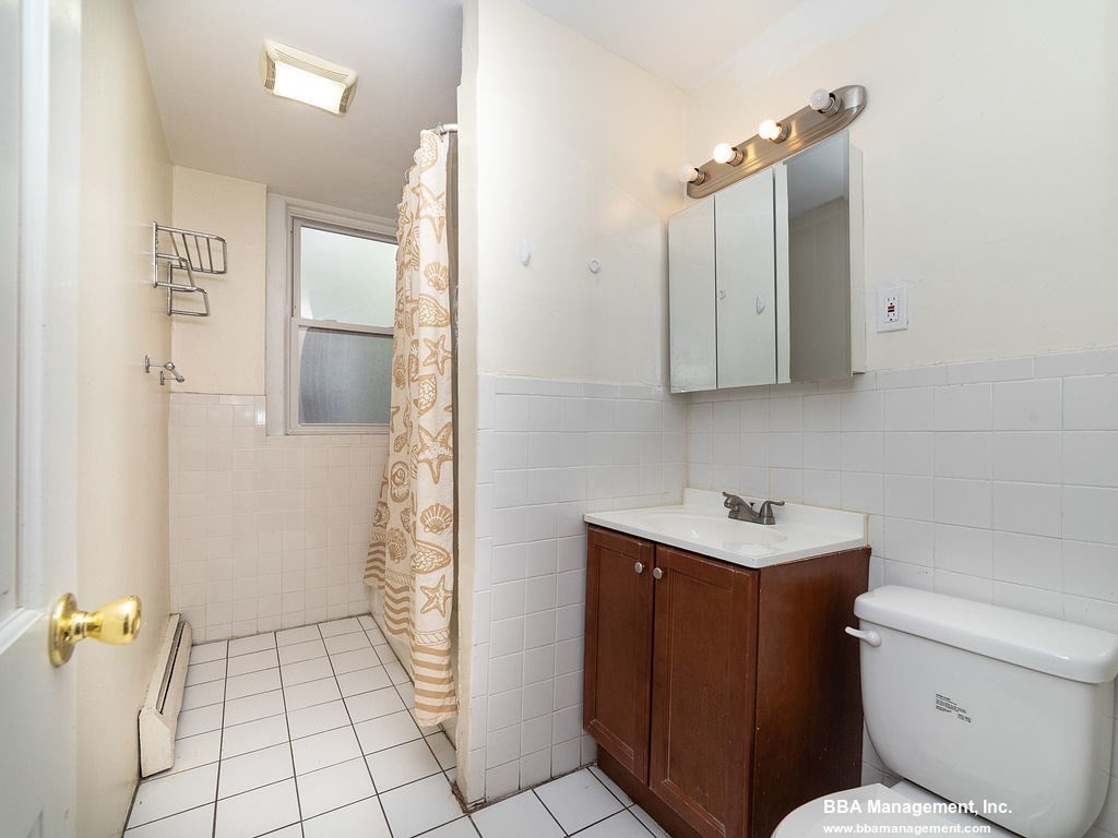 25 Chester Street, Unit 4 Boston, MA 02134 - Photo 9 of 12 a bathroom with a sink a toilet and shower