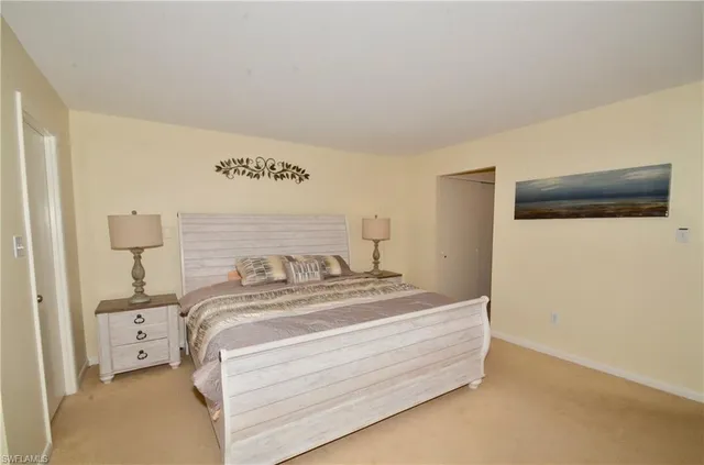 a bedroom with a bed and a night stand