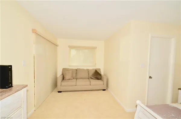 a room with a bed and flat screen tv