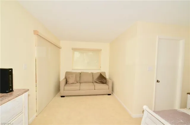 a room with a bed and flat screen tv