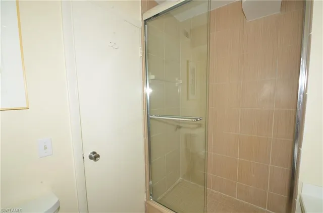 a bathroom with a glass shower door