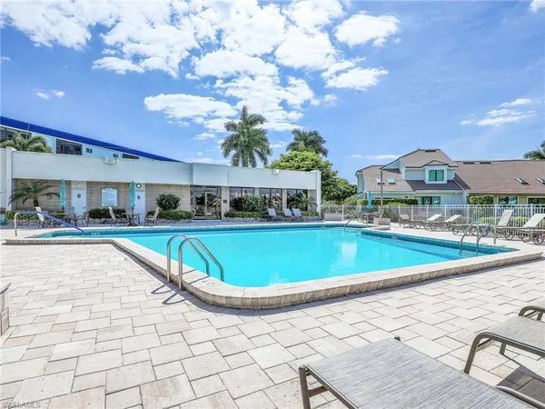 a view of an house with swimming pool and sitting area