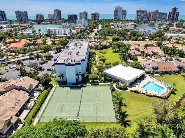 an aerial view of a house with a garden and lake view