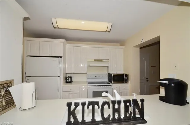 a kitchen with a refrigerator and a stove