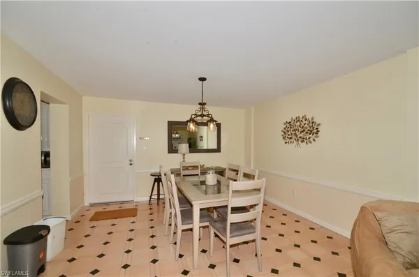 a dining room with furniture and a window