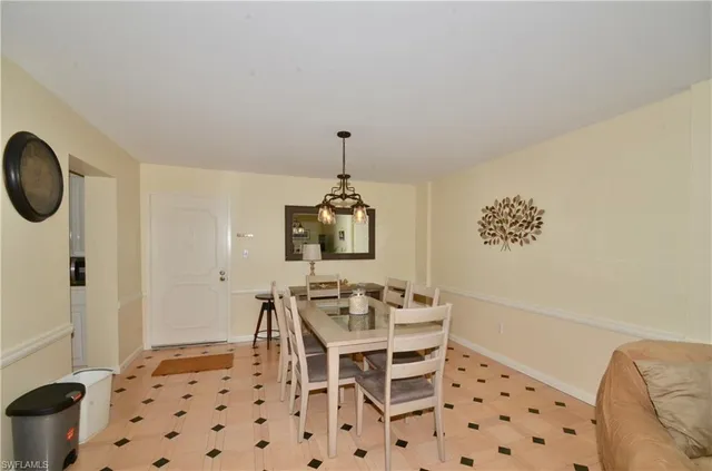 a dining room with furniture and a window