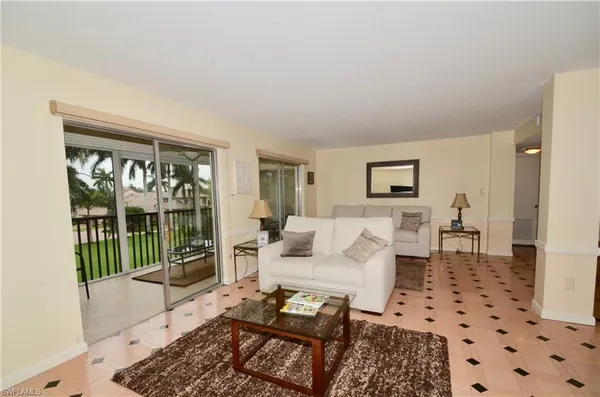 a living room with furniture and a rug