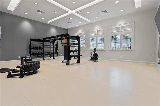 an empty room with gym equipment and a large window