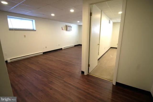 an empty room with wooden floor