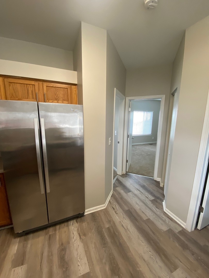 318 Richfield Trail Romeoville, IL 60446 - Photo 7 of 9 a view of a refrigerator in kitchen and wooden floor