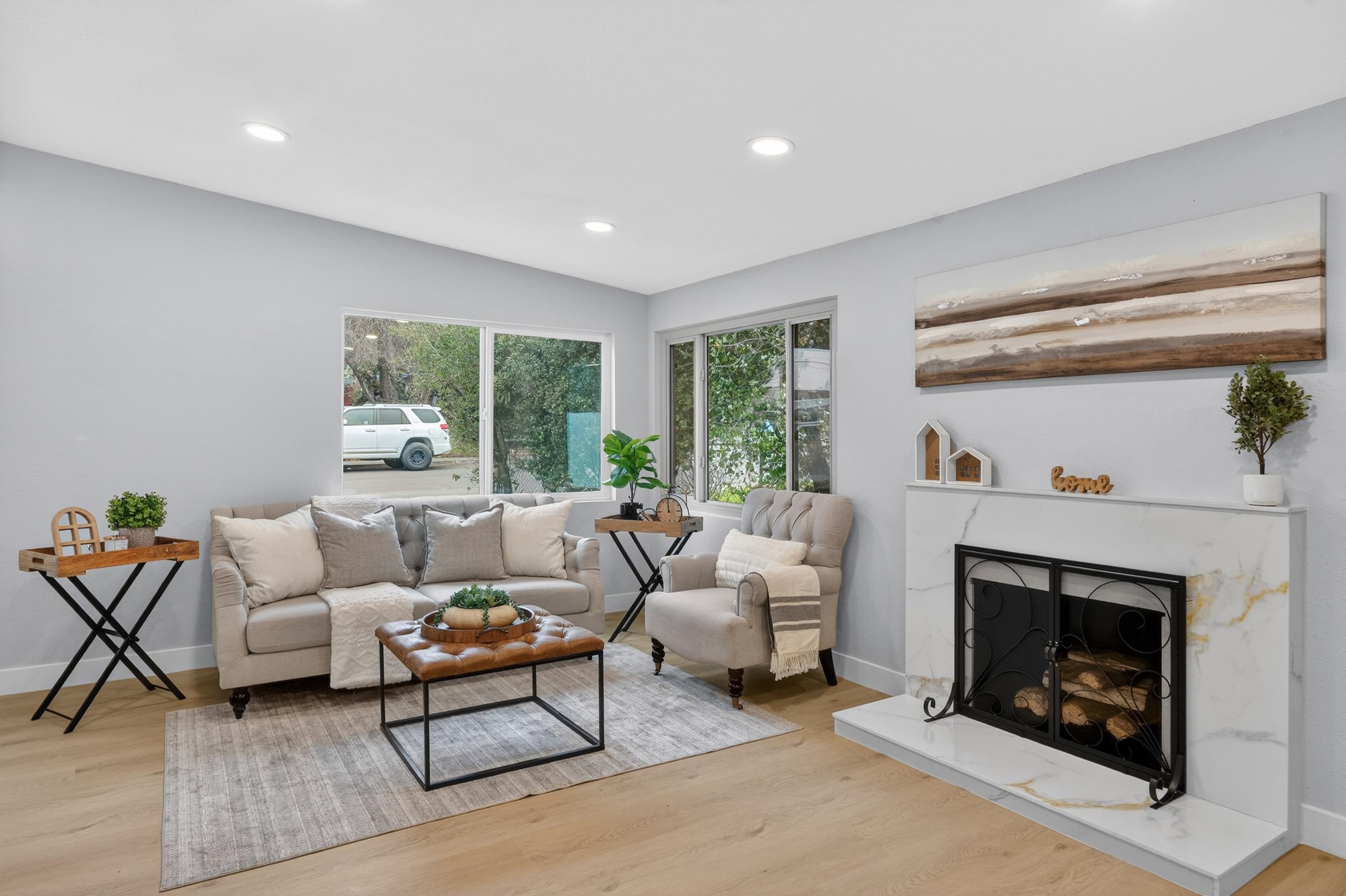 1241 Coronel Avenue Vallejo, CA 94591 - Photo 5 of 11 Living area featuring a fireplace with raised hearth, light wood-type flooring, recessed lighting, and lofted ceiling