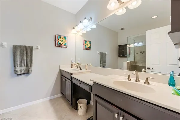 a bathroom with a double vanity sink and a mirror
