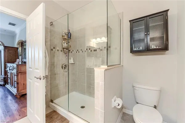 a bathroom with a toilet and a shower