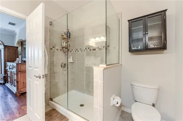 a bathroom with a toilet and a shower