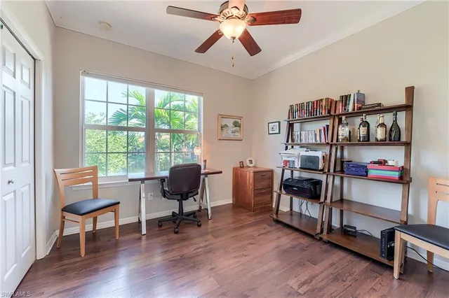 a view of a workspace with furniture and a window