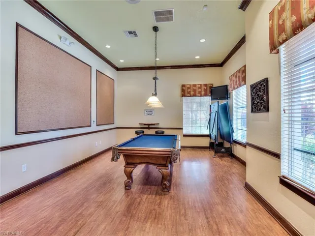 a room with wooden floor and furniture