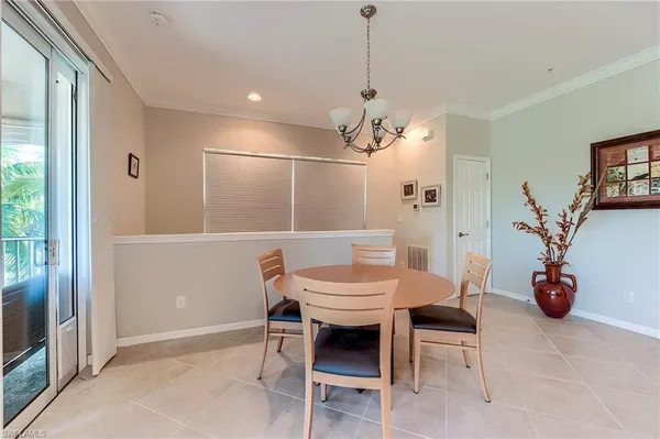 a view of a dining room with furniture and a chandelier