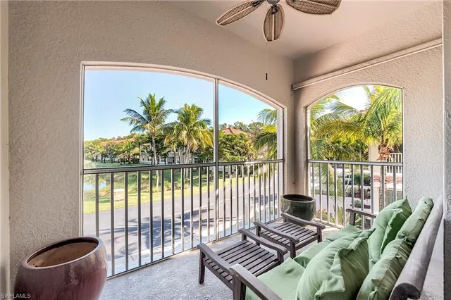 a living room with furniture and a floor to ceiling window