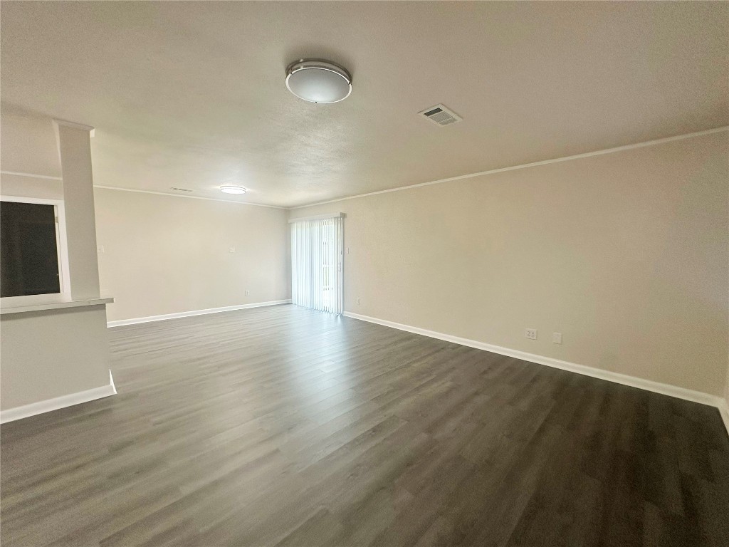 130 Bay Ridge Drive Baytown, TX 77523 - Photo 6 of 20 an empty room with wooden floor and windows