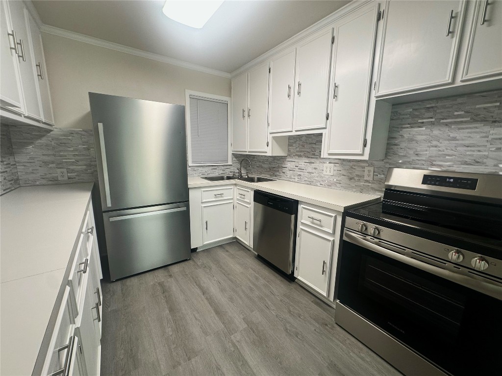 130 Bay Ridge Drive Baytown, TX 77523 - Photo 10 of 20 a kitchen with a refrigerator sink and stove top oven