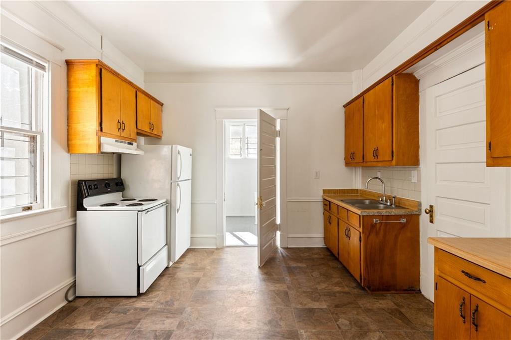 120 South Candler Street Decatur, GA 30030 - Photo 36 of 40 a kitchen with a stove a refrigerator and a sink