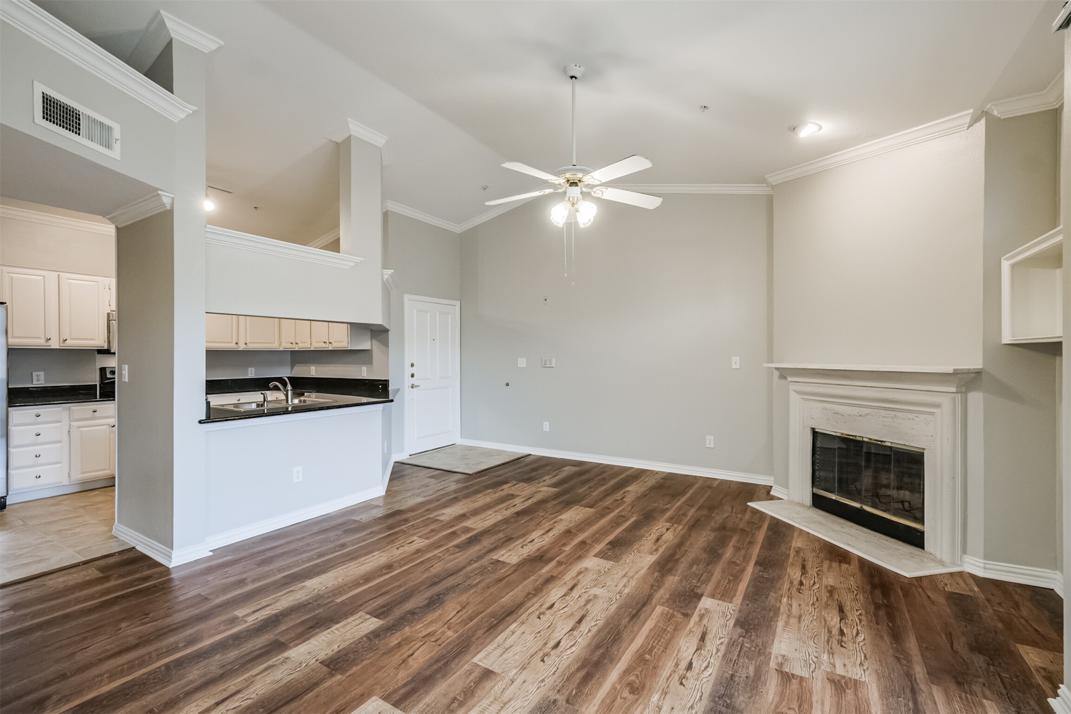 2111 Welch Street, Unit B304 Houston, TX 77019 - Photo 3 of 37 a view of empty room with wooden floor and fireplace