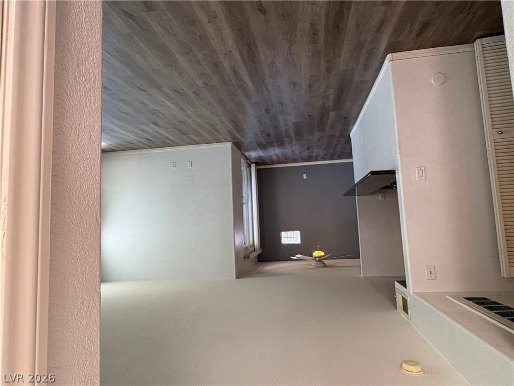 9325 West Desert Inn Road, Unit 123 Las Vegas, NV 89117 - Photo 36 of 36 The open floorplan features a modern kitchen area and a ceiling fan for comfort.