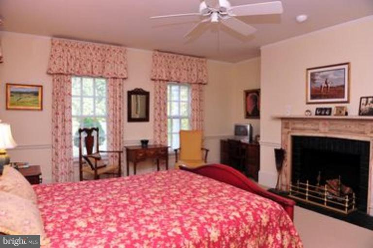 3032 Bull Run Mountain Road The Plains, VA 20198 - Photo 8 of 16 a bedroom with a bed and a fireplace