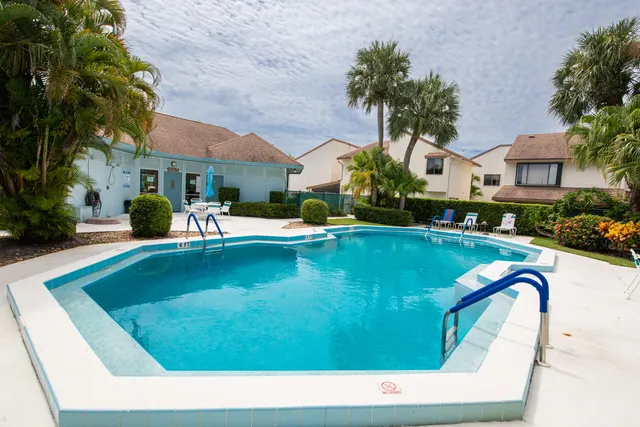 a swimming pool with outdoor seating and yard