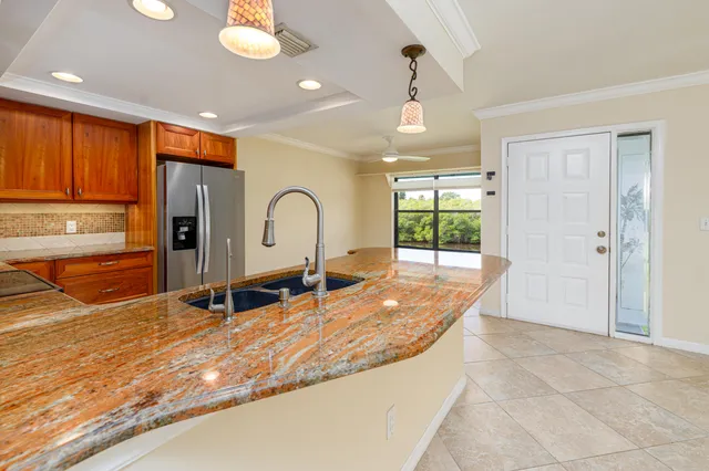 a view of a kitchen with a sink and cabinets