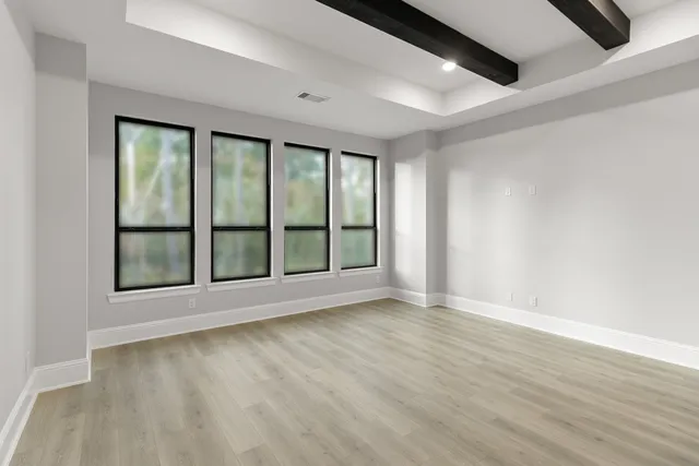 an empty room with chandelier fan