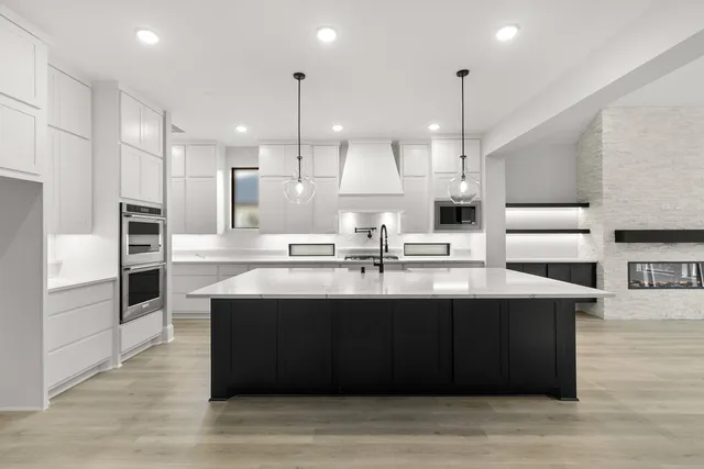 a spacious bathroom with a sink a large mirror and a bathtub