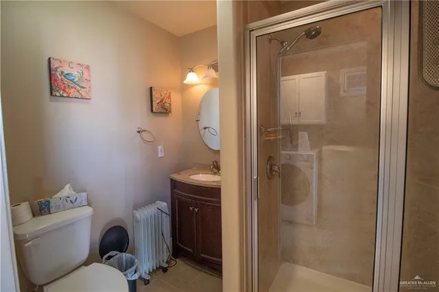 a bathroom with a toilet and a shower