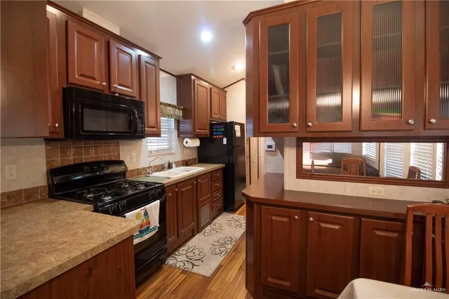 a kitchen with granite countertop cabinets stainless steel appliances and a counter space